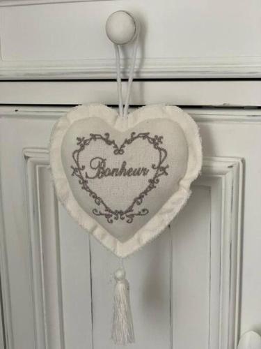 a heart hanging on a door with a tassel at Villa à 100 m à pied de la plage in Sainte-Anne