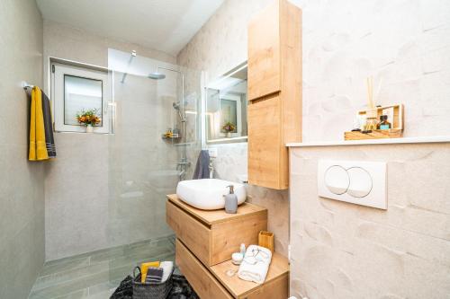 a bathroom with a sink and a shower at Apartments Villa Key in Cavtat