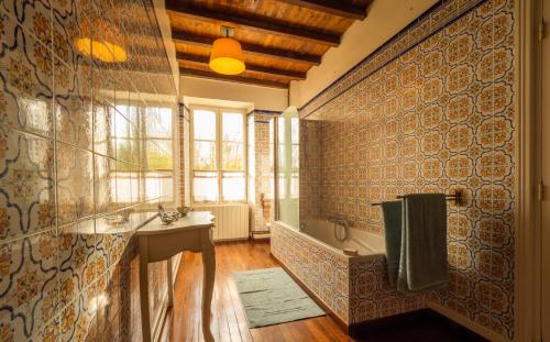 a bathroom with a sink and a bath tub at Moulin de Labique in Saint-Eutrope-de-Born