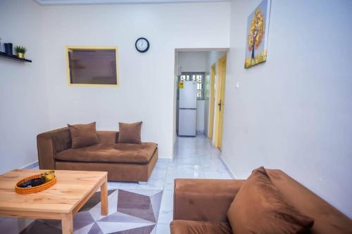 a living room with a couch and a table at BH Apartment in Kasoa