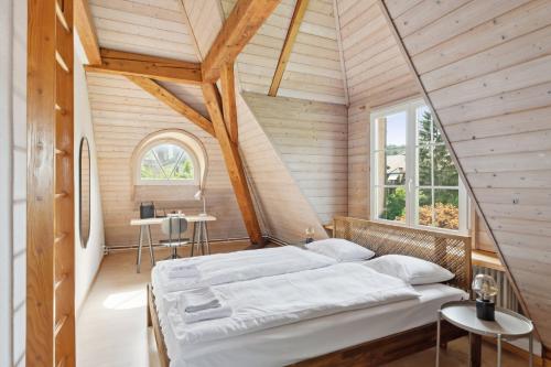 a bedroom with a large bed in a wooden ceiling at Centrally located House with garden in Zurich