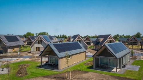 a row of houses with solar panels on the roofs at EuroParcs Cadzand in Cadzand