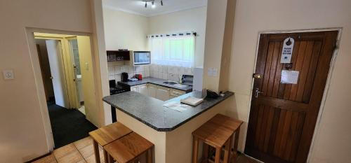 a small kitchen with a counter and a sink at Gooderson Drakensberg Gardens Golf & Spa Resort in Drakensberg Garden
