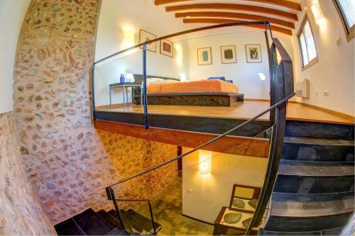 a bedroom with a bed and a spiral staircase at Son Genet by Vintage Travel in Búger