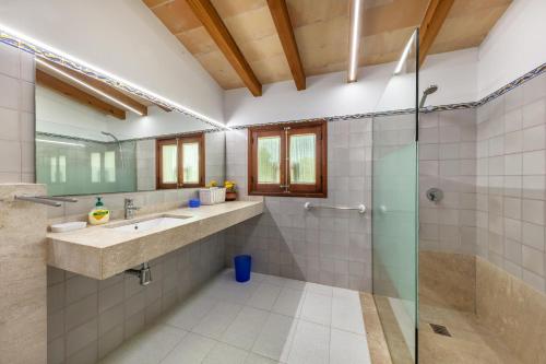 a bathroom with a shower and a sink at Villa Antonia in El Port