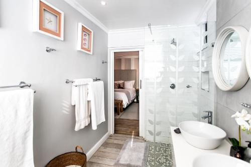 a bathroom with a shower and a sink at Serendipity in Hermanus