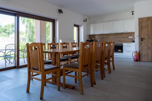a kitchen and dining room with a table and chairs at Penzion Tonička in Bulhary