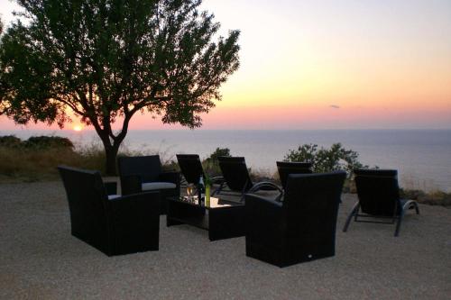 a group of chairs and a table and a tree at Ses Cases Noves by Vintage Travel in Banyalbufar