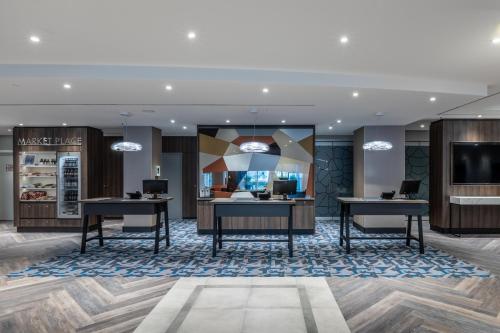 a lobby with two desks and a television at Radisson Blu Hotel Erfurt in Erfurt