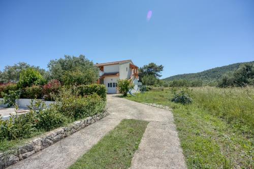 a villa with a view of a garden at Seaview Apartments in Pasman - Happy Rentals in Pašman