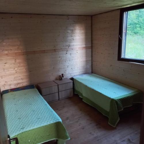 a room with two beds and a window at cottage dzama 