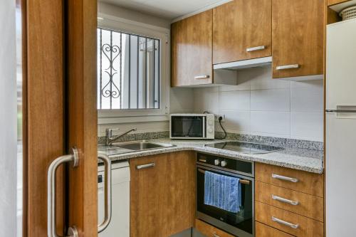 a kitchen with a sink and a microwave at Olga in Platja  d'Aro