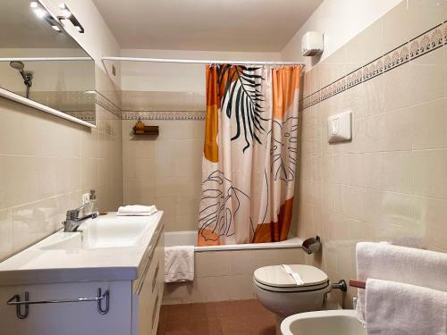 un bagno con lavandino, water e tenda da doccia di Apartment with view in Venice, Arsenale. a Venezia