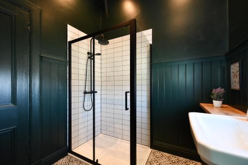 a bathroom with a shower and a sink at Prestwick Green Pad in Prestwick