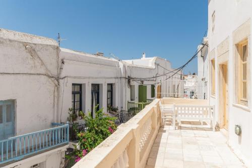 a view of an alley with a bench on a balcony at Cambanis Residence Mykonos Town in Mýkonos City