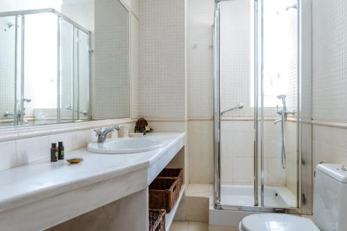 a bathroom with a sink and a shower and a toilet at Cambanis Residence Mykonos Town in Mýkonos City