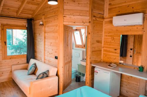 a living room with a couch in a tiny house at İnlice Ünzile Bungalow İNLİCE KAMP in Fethiye