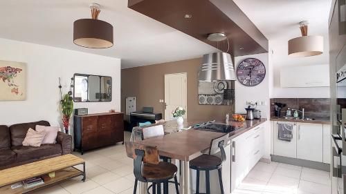une cuisine et un salon avec une table et un canapé dans l'établissement Appartement 7 personnes jardin et piscine, à La Ciotat