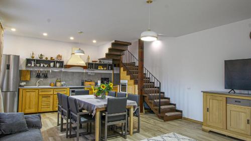 a kitchen and dining room with a table and a staircase at RunCa-n Rai in Cristian