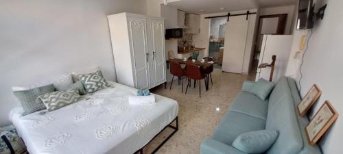 a living room with a couch and a blue sofa at Apartamento Don Manuel in Rincón de la Victoria