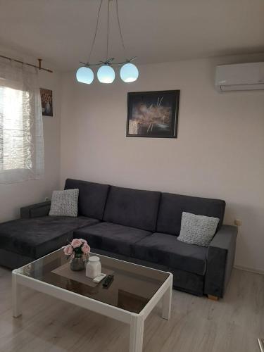 a living room with a couch and a coffee table at Apartman Vukoja - Posušje in Posušje