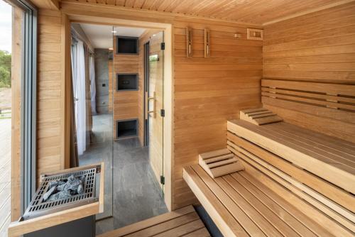 a sauna with two benches and a fireplace in a room at Penzion Včelařský Dvůr in Lednice