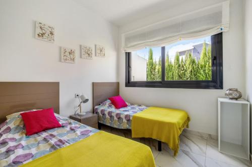 a room with two beds and a window at Bella Vista - House 4-6 people with swimming pool in San Miguel de Salinas in San Miguel de Salinas