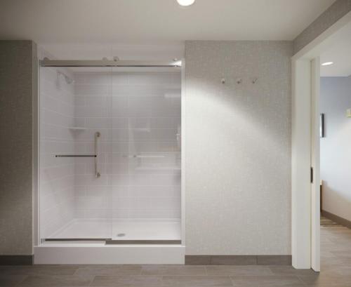 a bathroom with a shower with white walls at Hampton Inn Cleveland-Airport/Tiedeman Road in Brooklyn