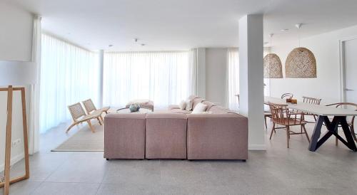a living room with a pink couch and a table at Duinhof in Cadzand-Bad