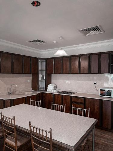 a kitchen with a table and chairs and a counter at Sea Club Resort in Dammam