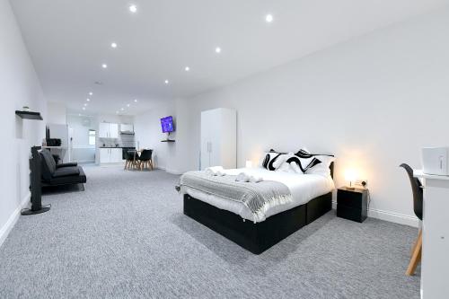 a bedroom with a bed and a living room at City Central Apartments in London