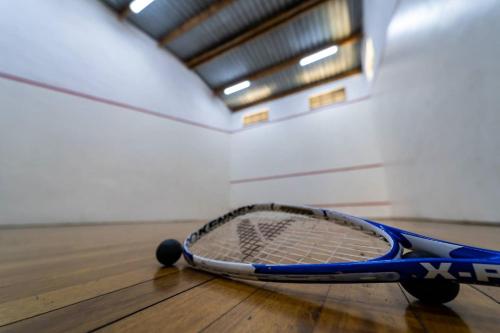 a tennis racket sitting on a tennis court at Gooderson Drakensberg Gardens Golf & Spa Resort in Drakensberg Garden