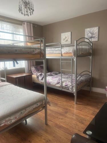a room with three bunk beds in it at Medway Stay in Chatham