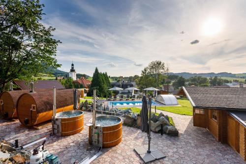 a backyard with a swimming pool and a house at Restaurace a penzion Pod Lipami Metylovice in Metylovice