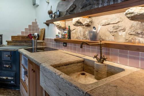 a kitchen with a sink and a counter top at Casa Carincio, Falesina Ospitar in Vignola