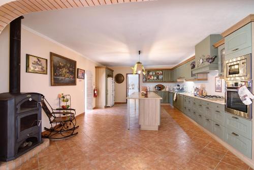 a large kitchen with a stove in the middle at At-tunis in Tunes