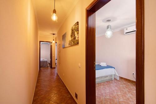 a hallway leading to a bedroom with a bed at At-tunis in Tunes