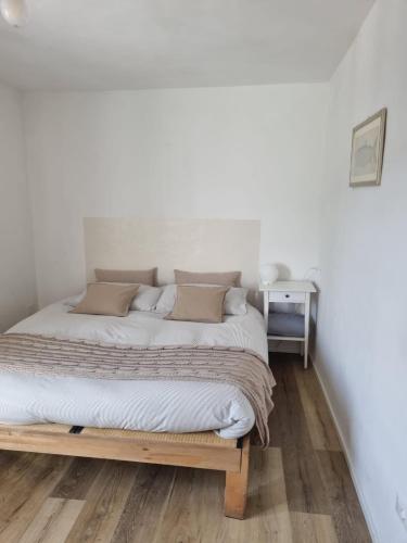 a bedroom with a large bed with a wooden frame at house in the medieval village in Apricale