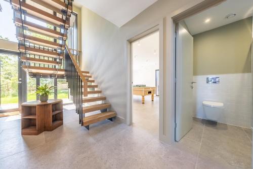 a bathroom with a staircase and a toilet in a house at The Grain Store in Reepham