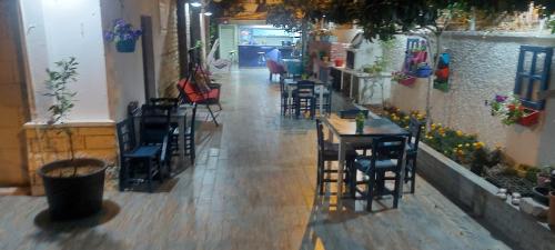an empty hallway with chairs and tables in a restaurant at ÇAMLIK PANSİYON in Antalya