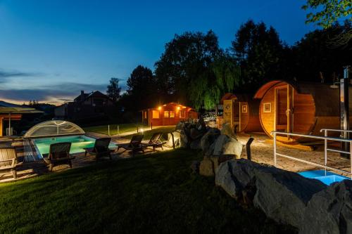 a night view of a yurt with a swimming pool at Restaurace a penzion Pod Lipami Metylovice in Metylovice