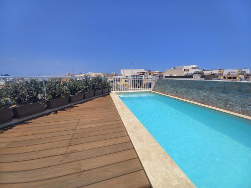 a swimming pool on the roof of a building at Luxury Penthouse with private pool in Tas-Samra