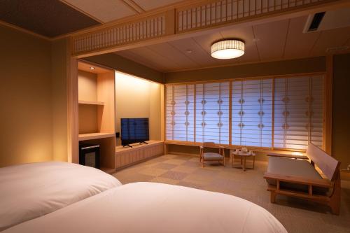 Cama o camas de una habitación en 猿投温泉金泉閣