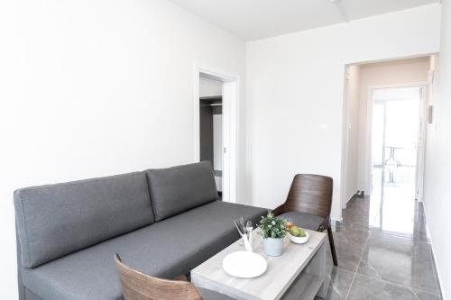 a living room with a couch and a table at Blazer Residence in Larnaka