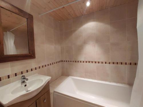 a bathroom with a sink and a bath tub at Appartement Les Arcs 1800, 3 pièces, 4 personnes - FR-1-411-479 in Arc 1800