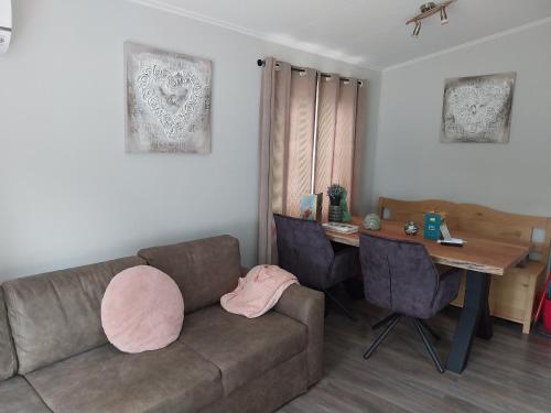 a living room with a couch and a table at BPW 1105 - Bospark t Wolfsven in Mierlo