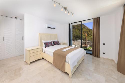 a bedroom with a bed and a large window at Luxury Sea View Villa w Pool Near Beach in Kalkan in Kalkan
