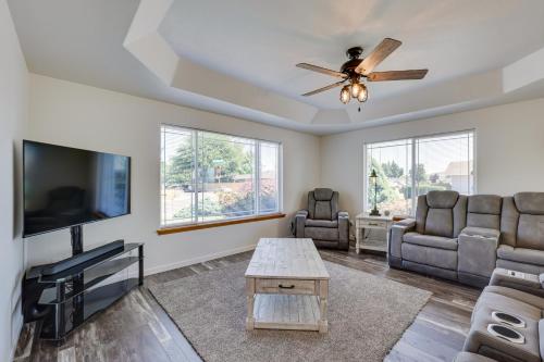 a living room with a ceiling fan and a tv at Charming Rogue Valley Home in Central Point! in Central Point