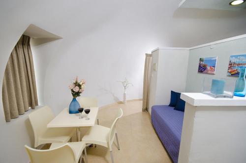 a room with a couch and a table with chairs at Dor village in Dor