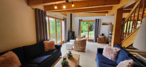 a living room with a couch and a table at Chalet Chez Cheryl, Mayens-de-Chamoson in Ovronnaz